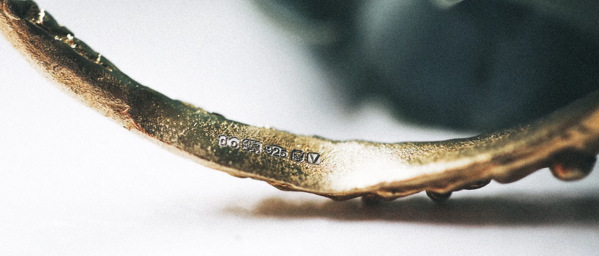Close-up of the London Assay Office hallmark stamped inside a hand-textured cuff bangle
