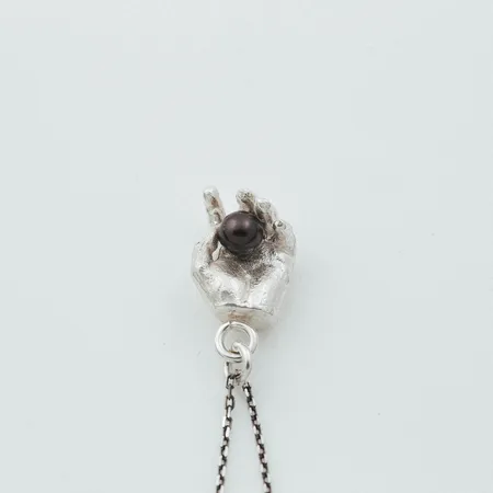 Oro | Silver Hand Holding Black Pearl Pendant